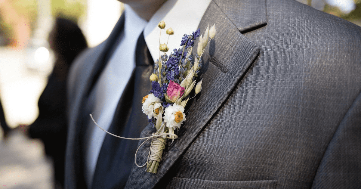 Charcoal grey suit matched with a white shirt and black tie